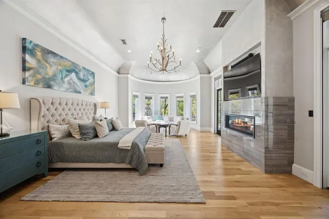 a living room with furniture a chandelier and a large window