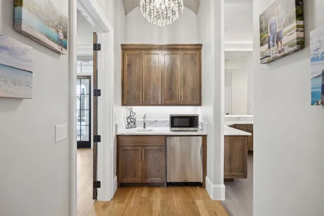 a bedroom with a large bed and a chandelier