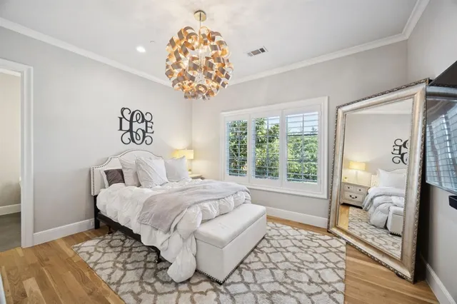 a spacious bedroom with a bed and a large window