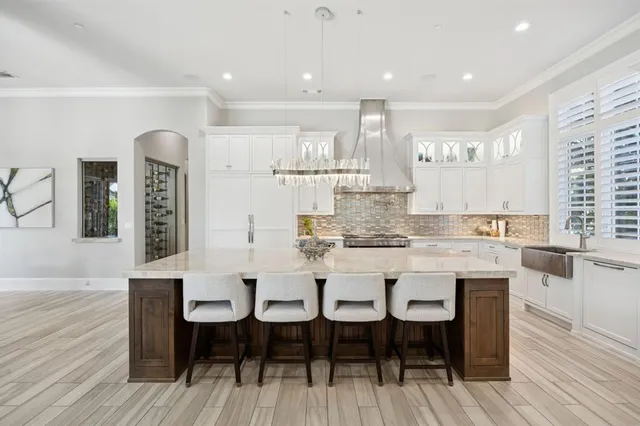 a large kitchen with a table and chairs