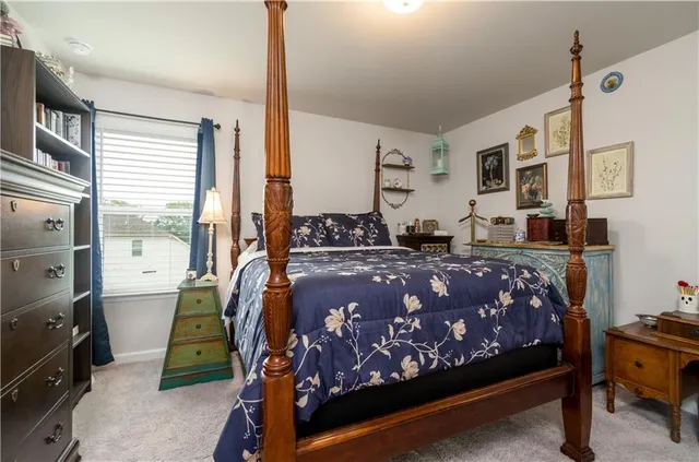 a bed sitting in a bedroom next to a window