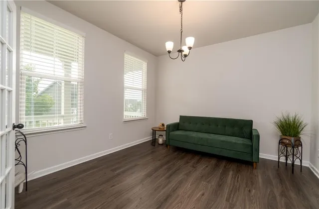 a living room with furniture and a ceiling fan