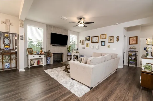 a living room with furniture fireplace and flat screen tv
