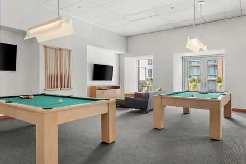 a room with furniture a flat screen tv and a table