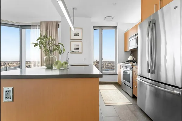 a kitchen with stainless steel appliances a refrigerator and a counter space