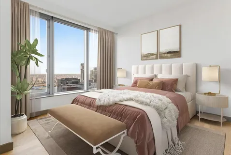 a spacious bedroom with a bed and a large window