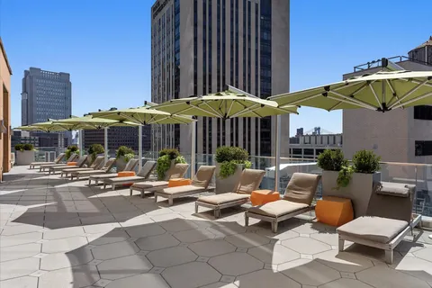 a view of a patio with a table and chairs under an umbrella