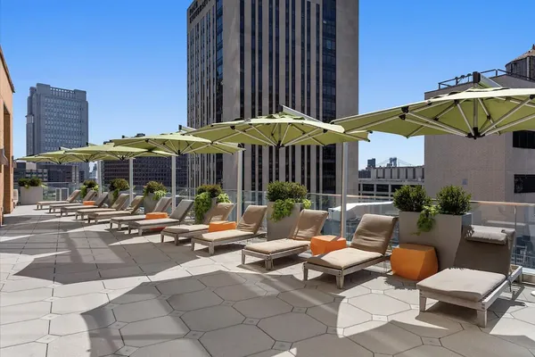 a view of a patio with a table and chairs under an umbrella