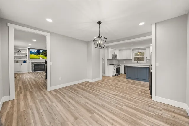 a view of a kitchen with a sink and wooden floor