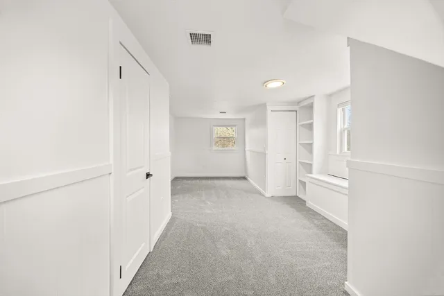 a view of a big room with closet and windows