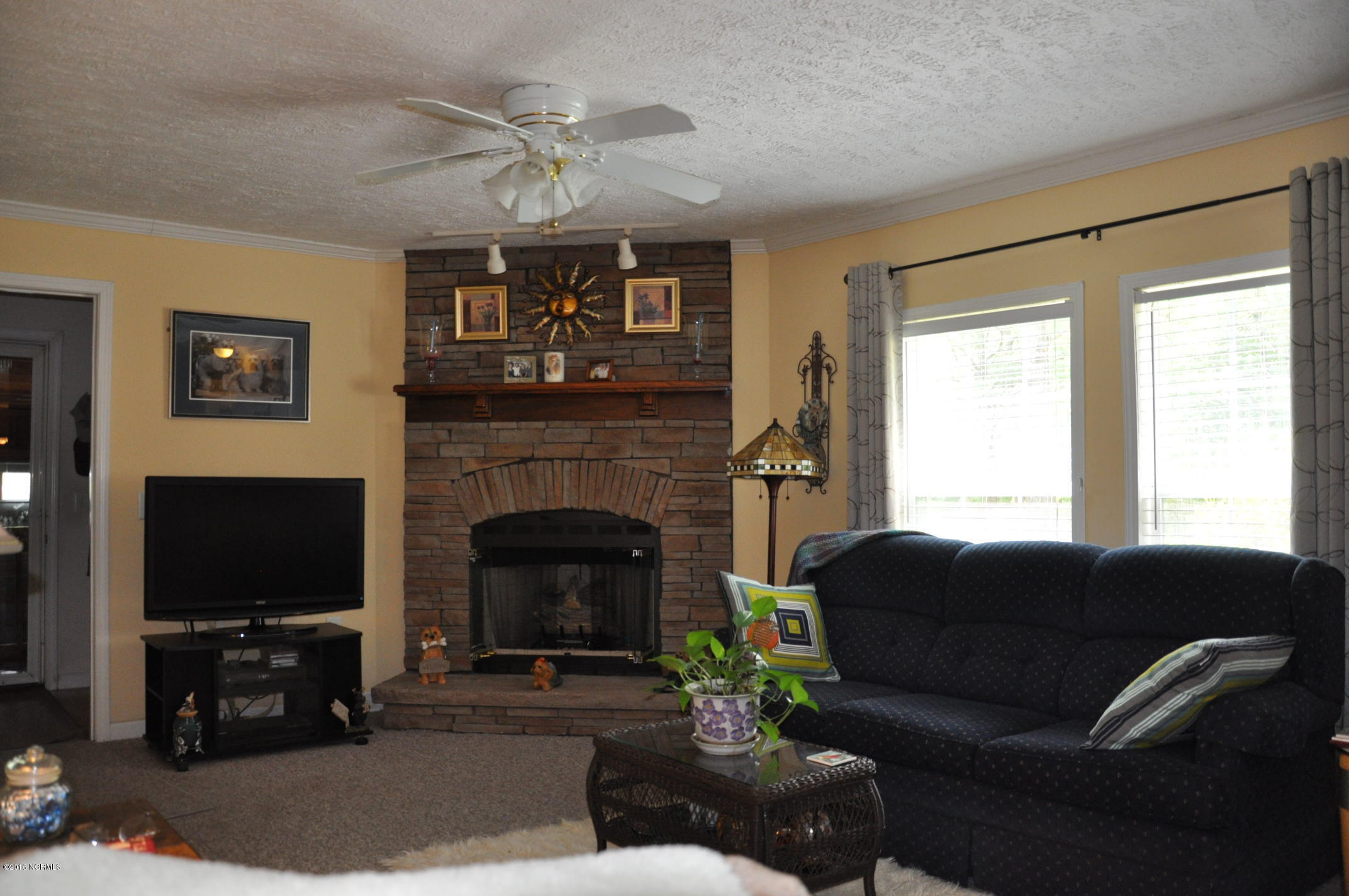 6882 Maple Road Northwest Ash, NC 28420 - Photo 2 of 35 Fireplace in the Den off of the Utility Room and the two car garage.
