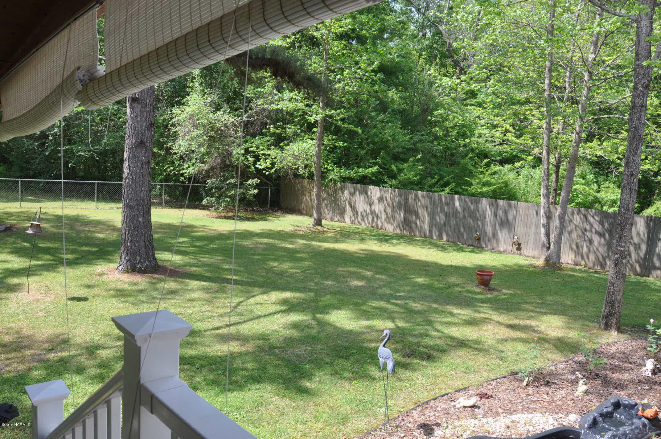 6882 Maple Road Northwest Ash, NC 28420 - Photo 23 of 35 This is the view from the dining area of the rear fenced in yard.