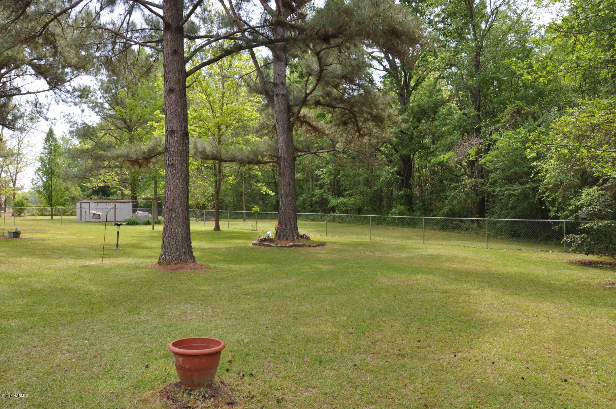 6882 Maple Road Northwest Ash, NC 28420 - Photo 25 of 35 Plenty of room for your pets or a garden in the fenced in rear yard at 6882 Maple Lane.