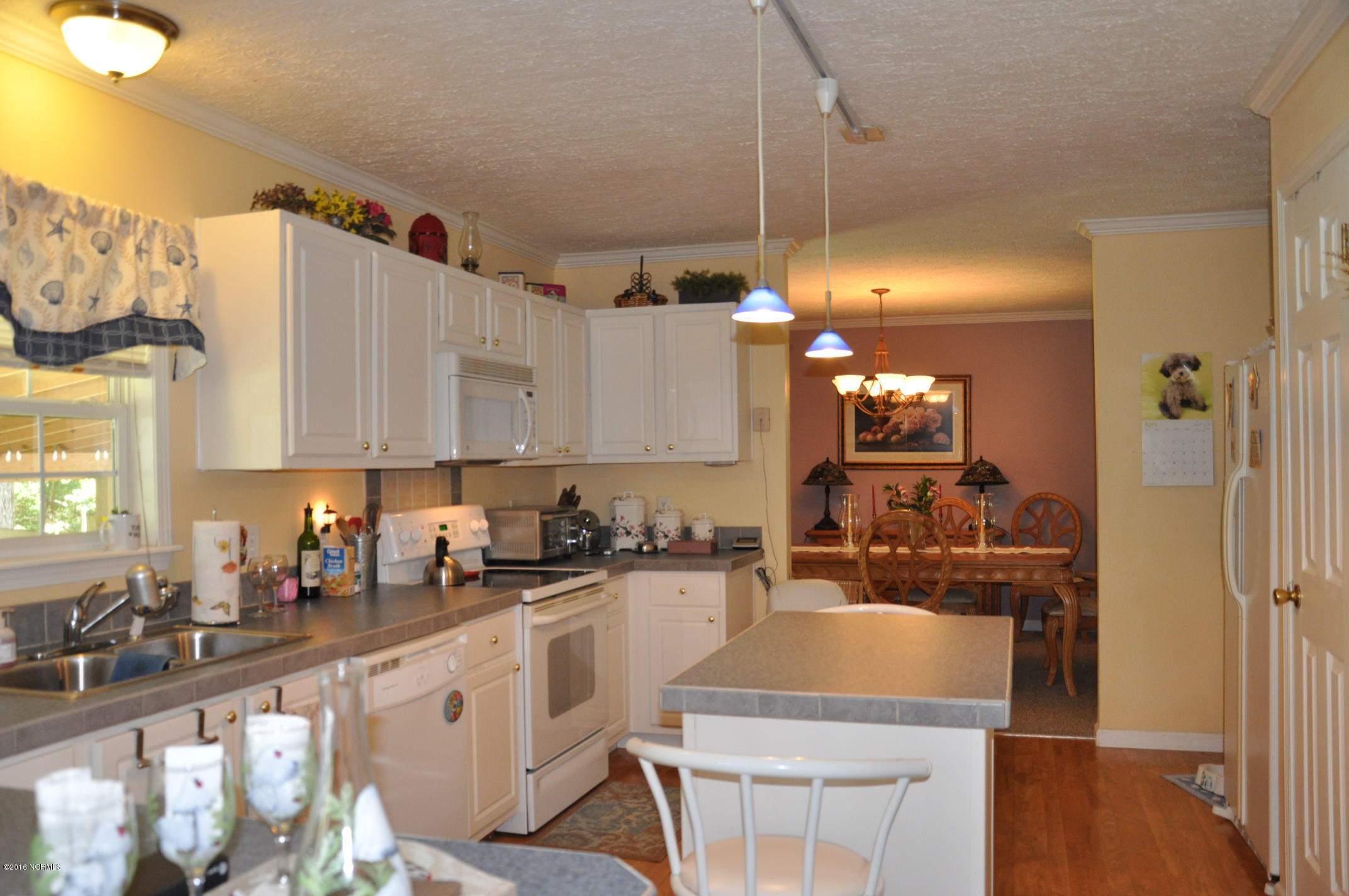 6882 Maple Road Northwest Ash, NC 28420 - Photo 3 of 35 Center island with pendant lighting to assist you with daily kitchen tasks.