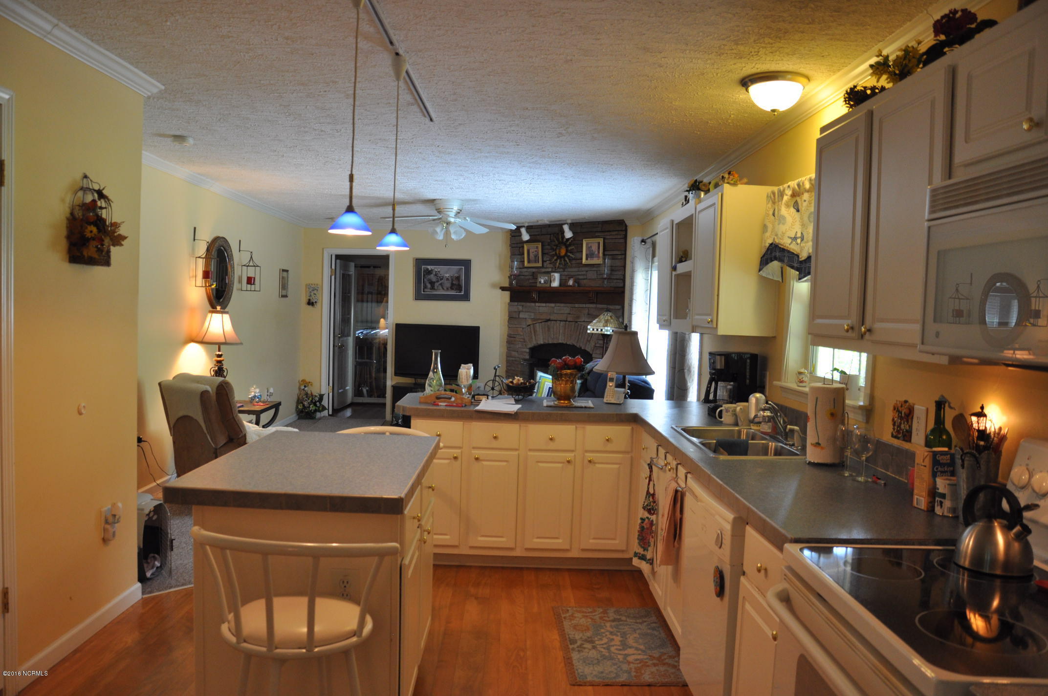 6882 Maple Road Northwest Ash, NC 28420 - Photo 33 of 35 As you pass through the kitchen, to the left of the den is a bedroom, with a sitting area and full bathroom. Split floor plan allows privacy for your guests.