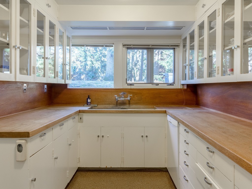 106 Sargent Road Brookline, MA 02445 - Photo 11 of 20 a open kitchen with granite countertop a sink and dishwasher with a large window