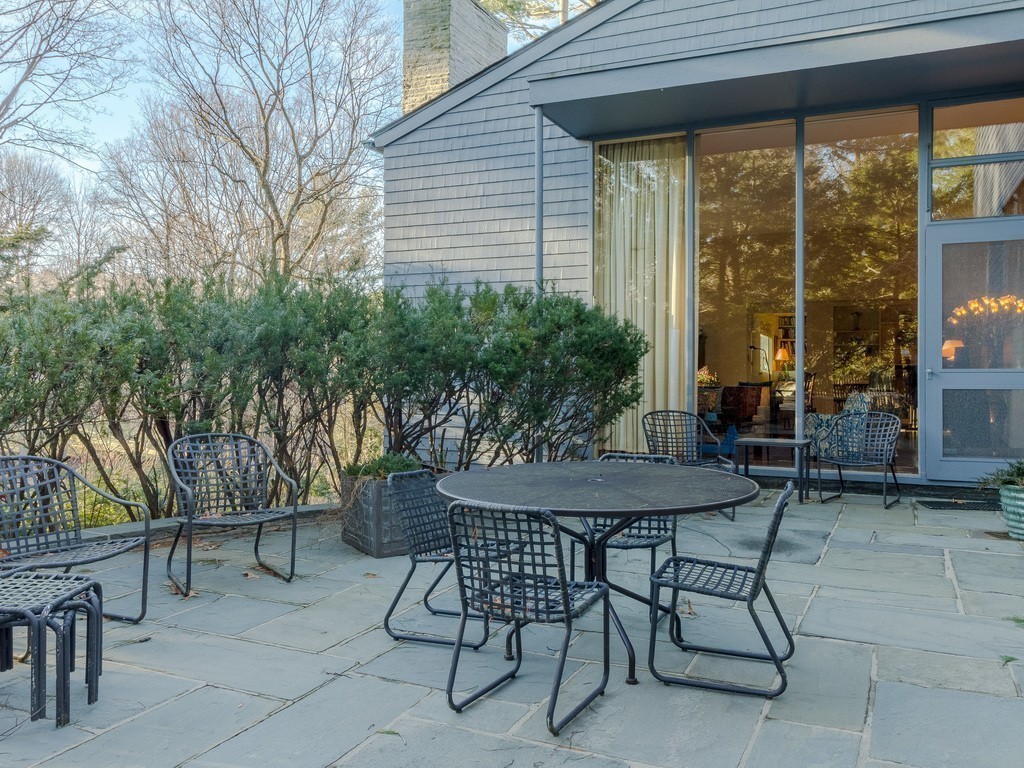 106 Sargent Road Brookline, MA 02445 - Photo 4 of 20 a view of a patio with a table and chairs next to a yard
