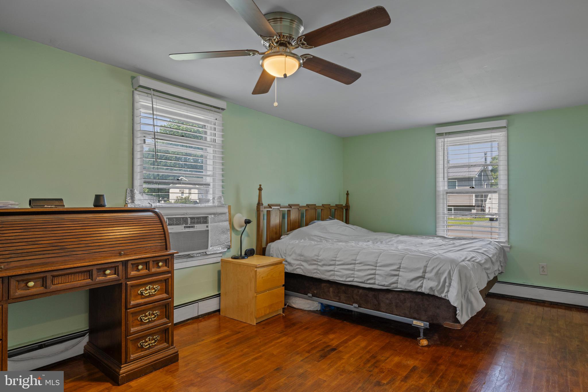 102 Roe Street Greensboro, MD 21639 - Photo 18 of 42 a bedroom with a bed and a chandelier