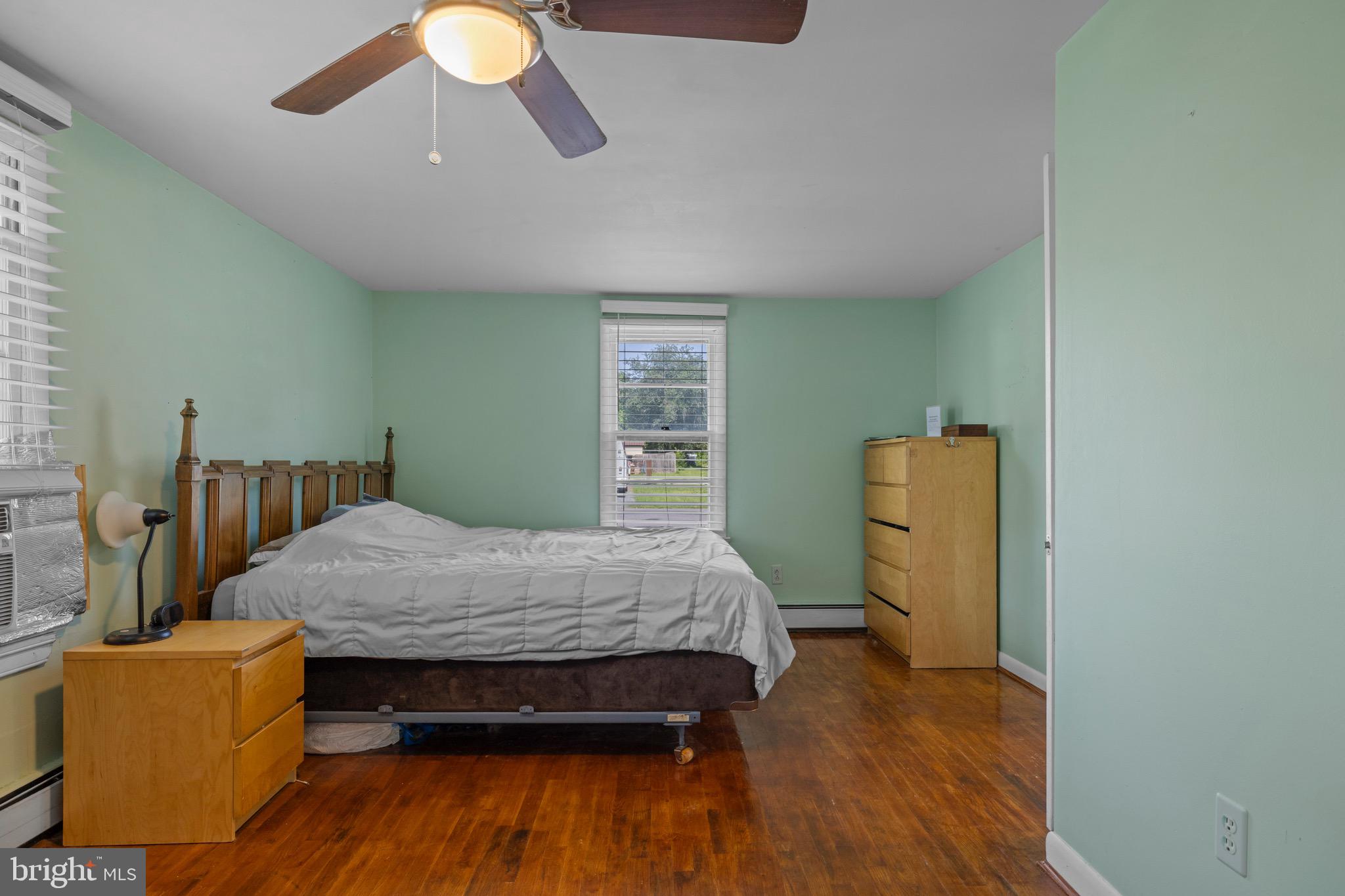 102 Roe Street Greensboro, MD 21639 - Photo 20 of 42 a bedroom with bed and a chandelier