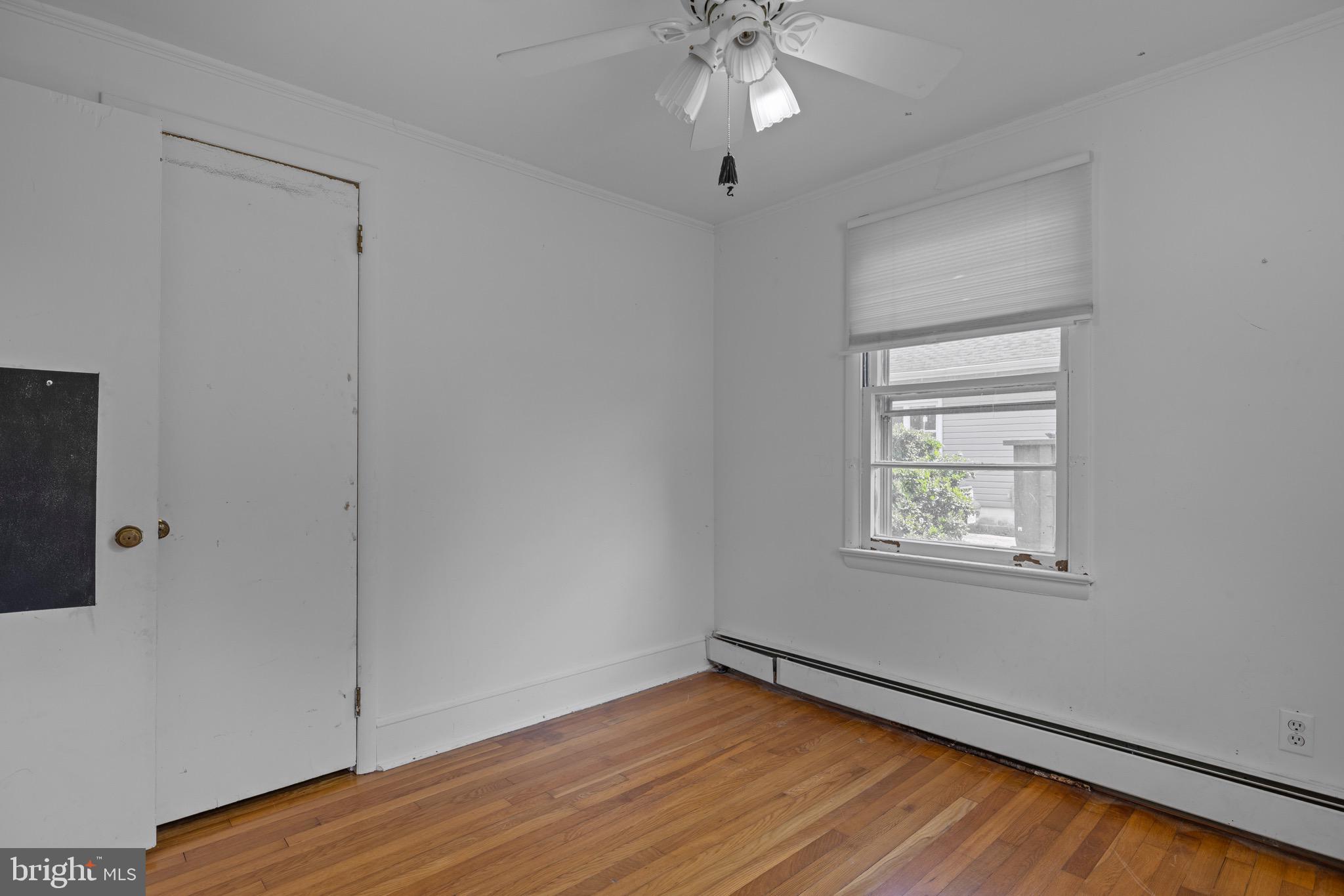 102 Roe Street Greensboro, MD 21639 - Photo 26 of 42 a view of an empty room with wooden floor and a window