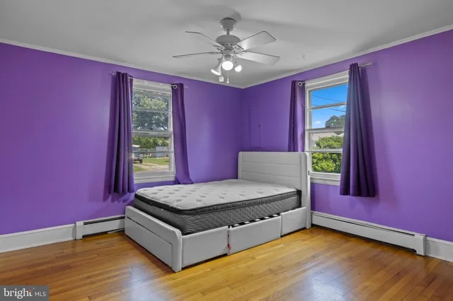 a spacious bedroom with a bed and a chandelier