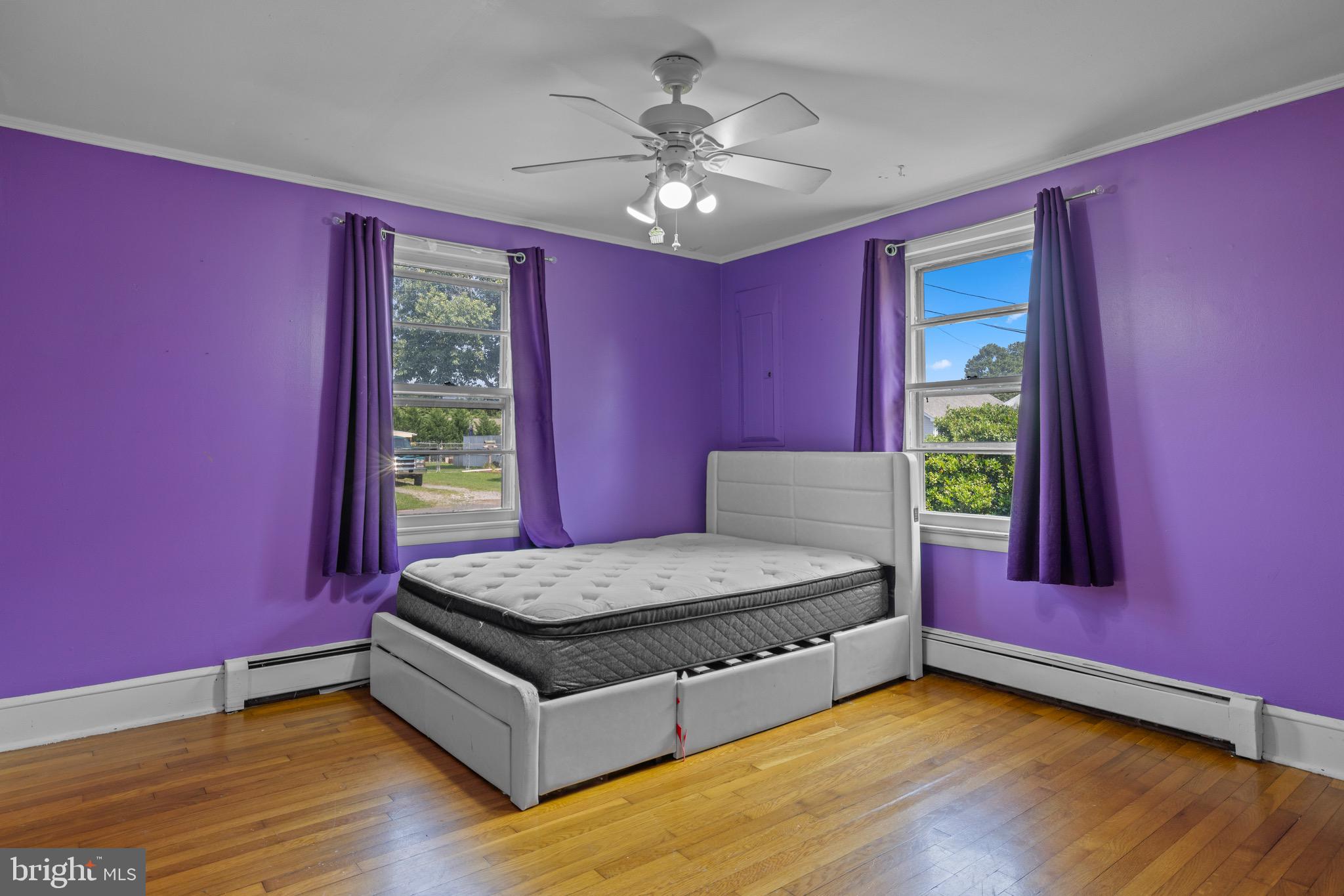 102 Roe Street Greensboro, MD 21639 - Photo 27 of 42 a spacious bedroom with a bed and a chandelier