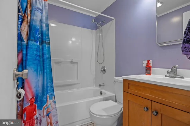 a bathroom with a sink toilet vanity and shower