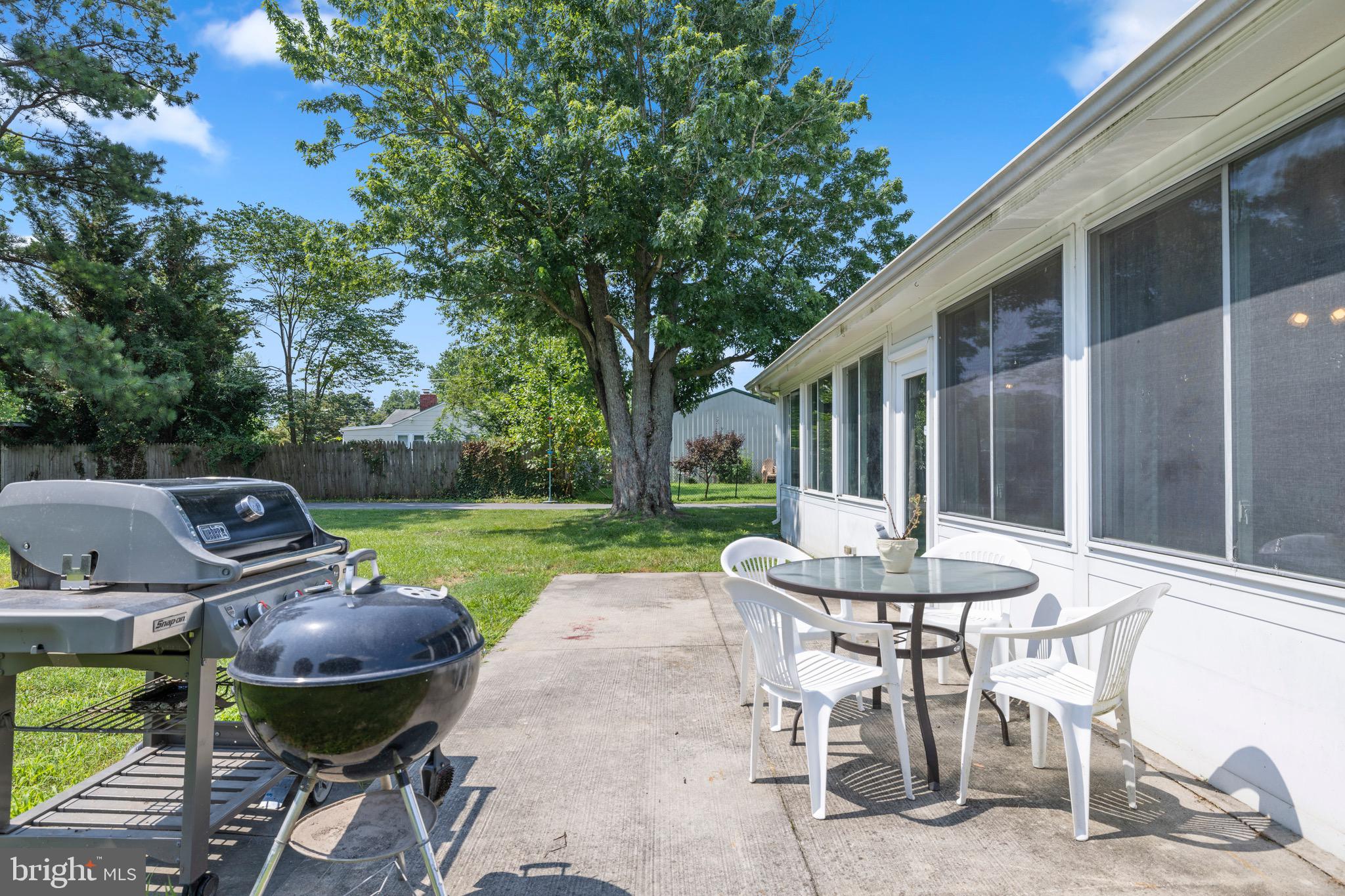 102 Roe Street Greensboro, MD 21639 - Photo 36 of 42 a view of a patio with table and chairs and a barbeque