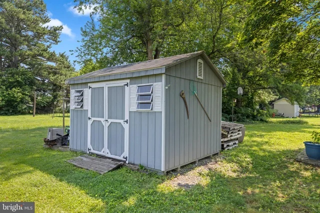 a view of backyard with tub and trees in the background