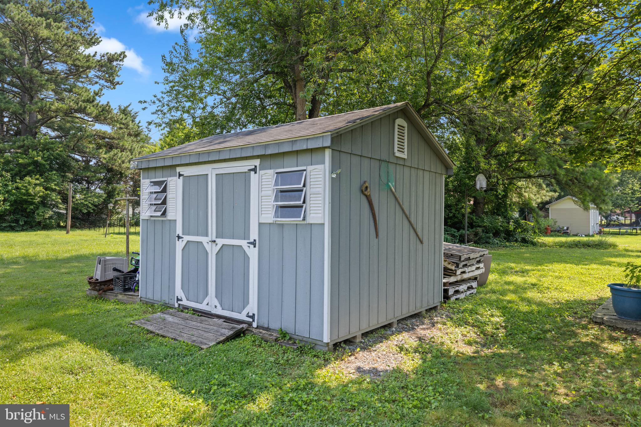 102 Roe Street Greensboro, MD 21639 - Photo 37 of 42 a view of backyard with tub and trees in the background
