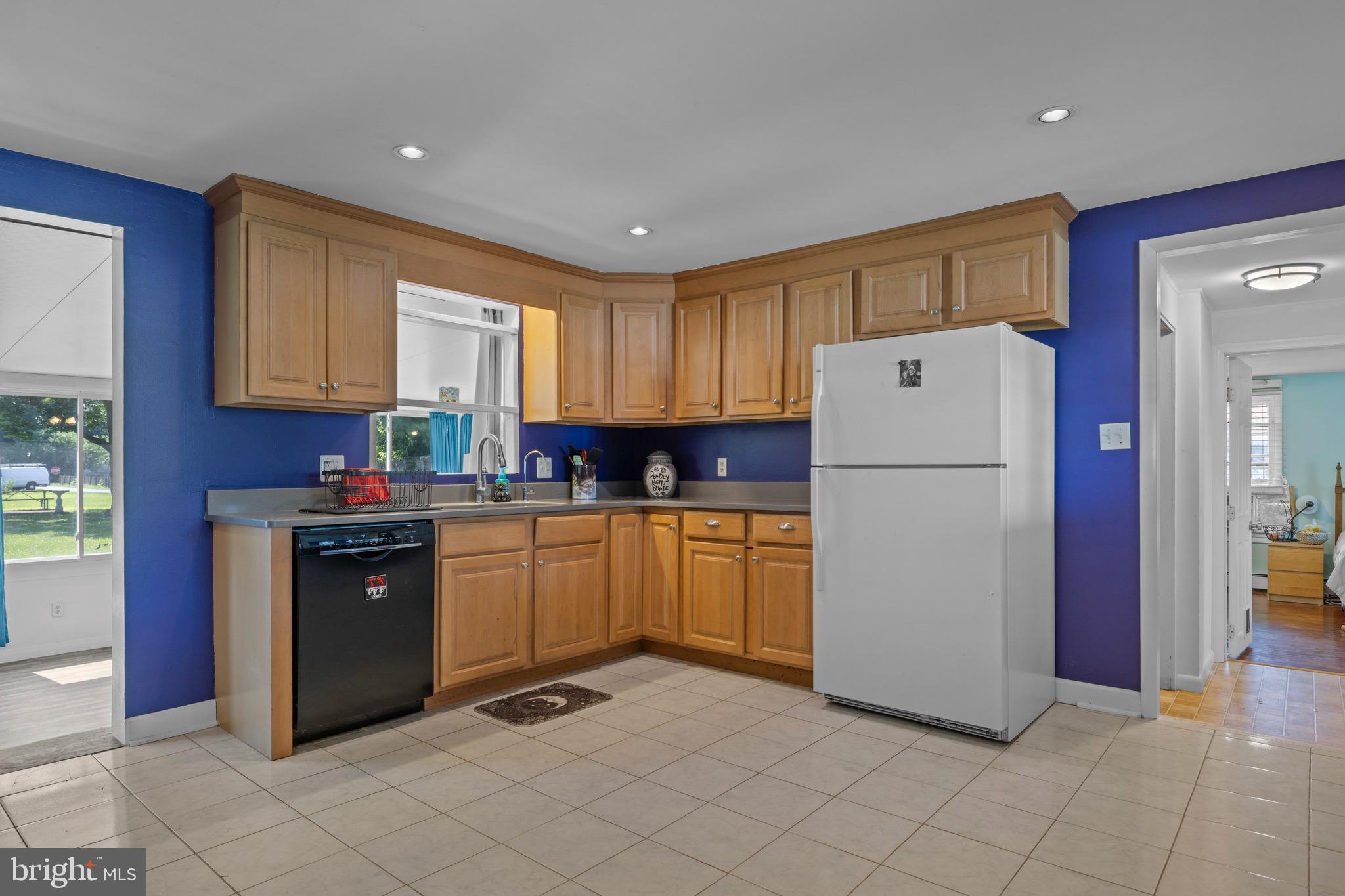 102 Roe Street Greensboro, MD 21639 - Photo 5 of 42 a kitchen with a refrigerator sink and cabinets