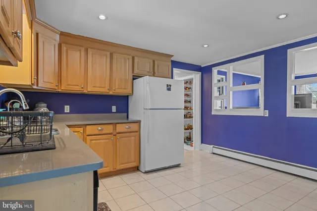 a white refrigerator freezer sitting in a kitchen