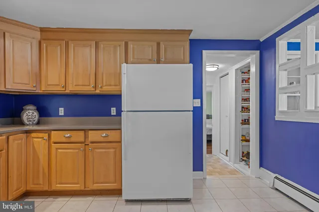 a kitchen with stainless steel appliances granite countertop a refrigerator and a stove
