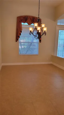 a view of a room with wooden floor and windows