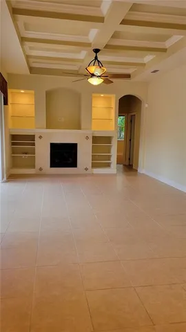 a view of a livingroom with an empty space and a fireplace