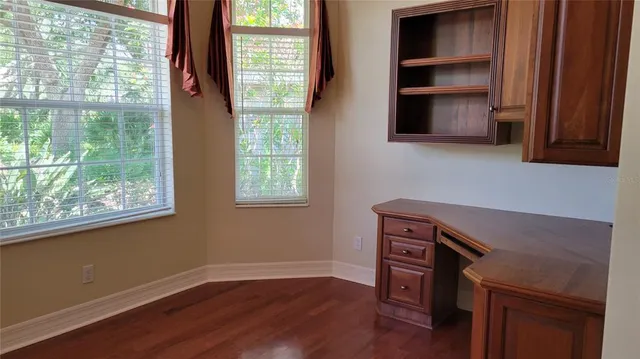 a view of cabinets and wooden floor in a kitchen