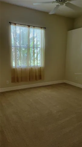 a view of a small space with wooden floor and a window
