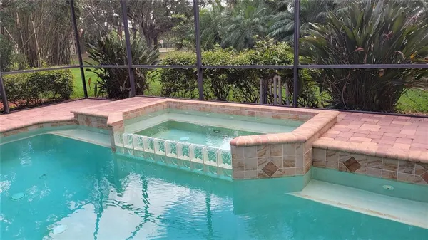 a view of swimming pool with a garden and seating area