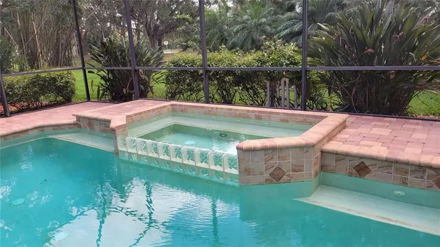 a view of swimming pool with a garden and seating area