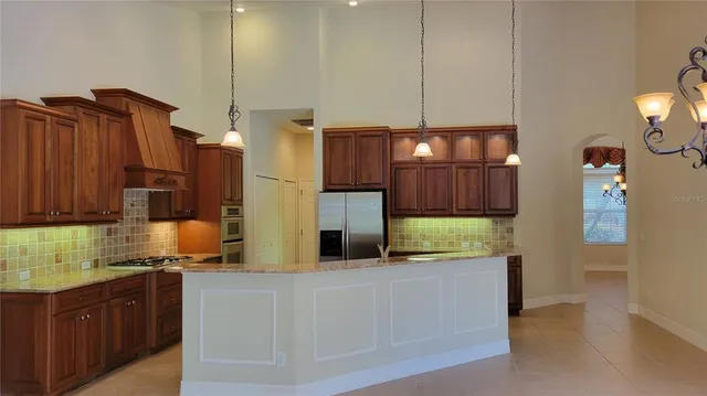 a kitchen with stainless steel appliances wooden cabinets a stove and a refrigerator