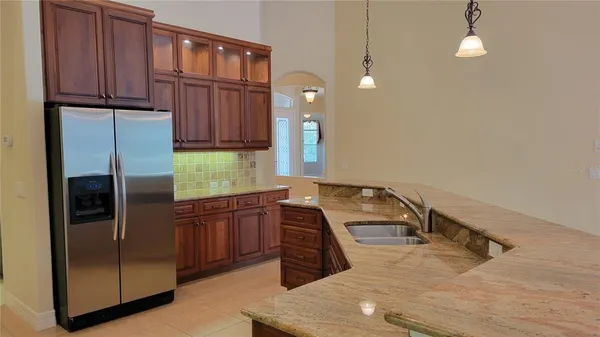 a kitchen with a refrigerator and a sink