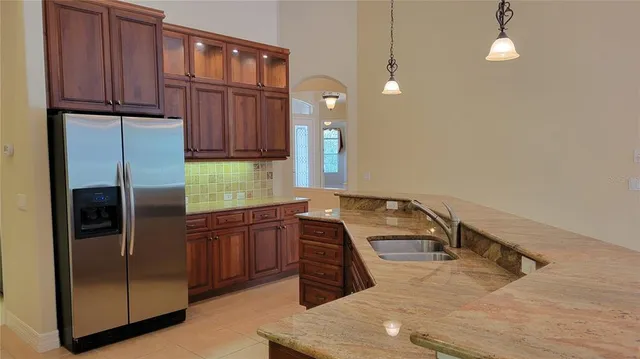 a kitchen with a refrigerator and a sink