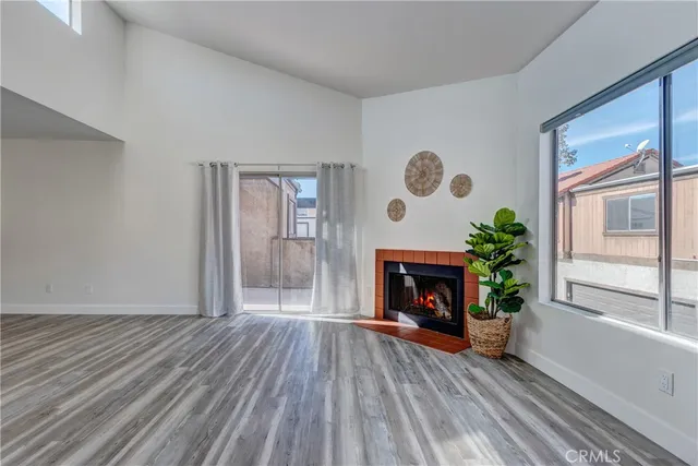a view of a hallway with wooden floor and a glass door