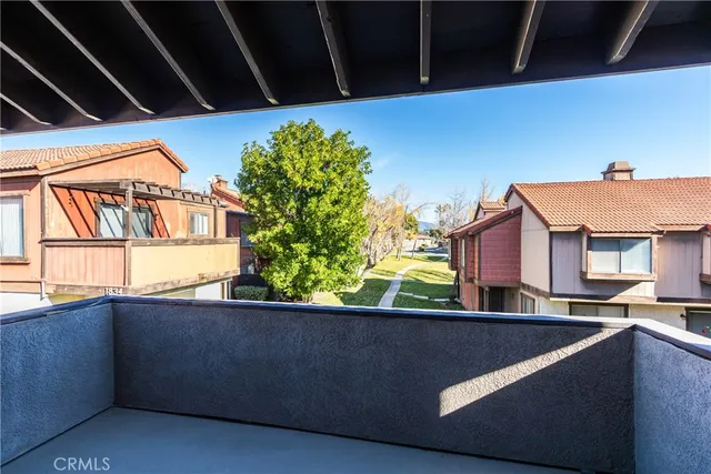 a view of a patio with couches table and chairs and potted plants