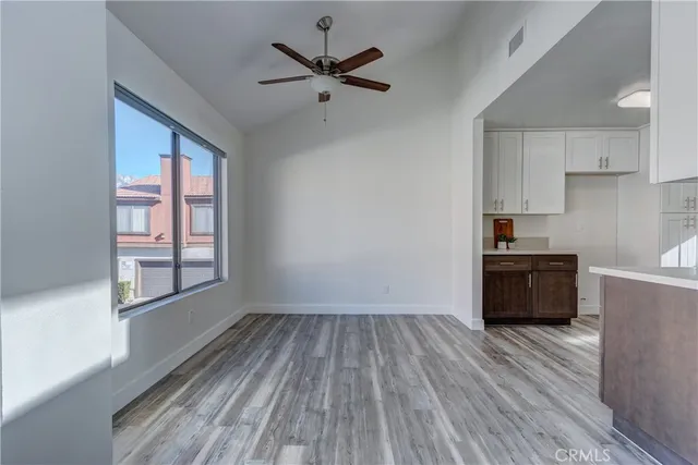 a kitchen with stainless steel appliances wooden floors and wooden cabinets