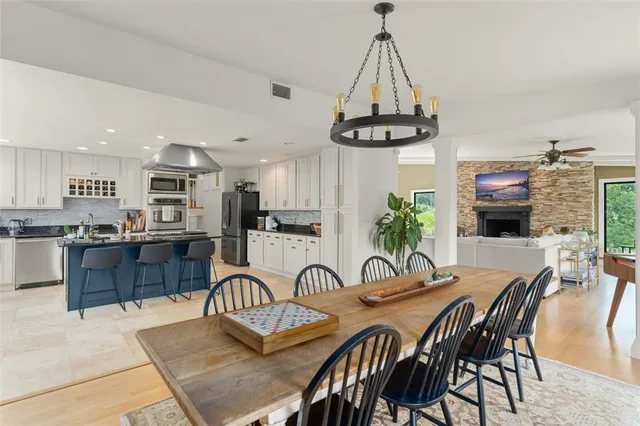 a kitchen with stainless steel appliances granite countertop a stove a sink dishwasher and cabinets with wooden floor