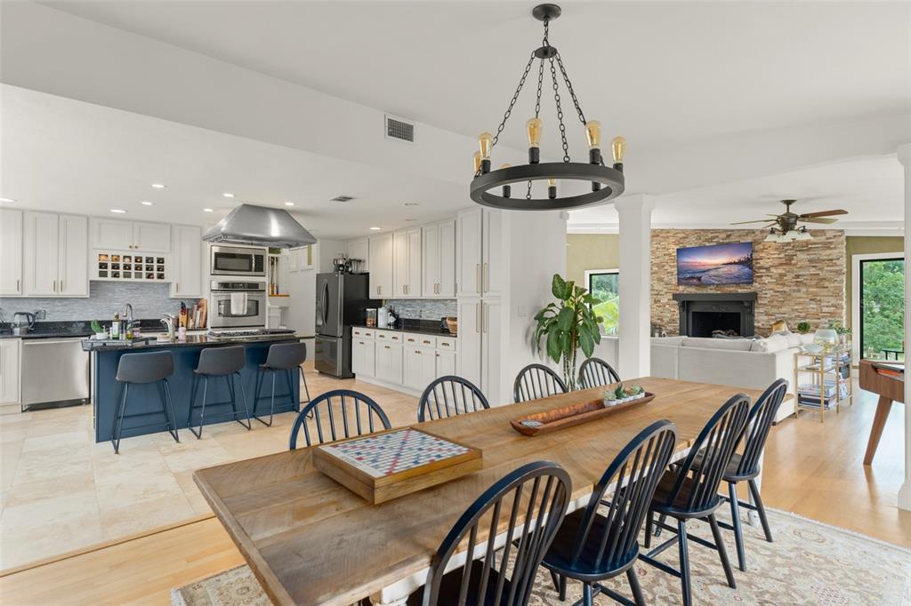 101 Lee Street Windermere, FL 34786 - Photo 18 of 63 a view of a dining room with furniture a kitchen and chandelier