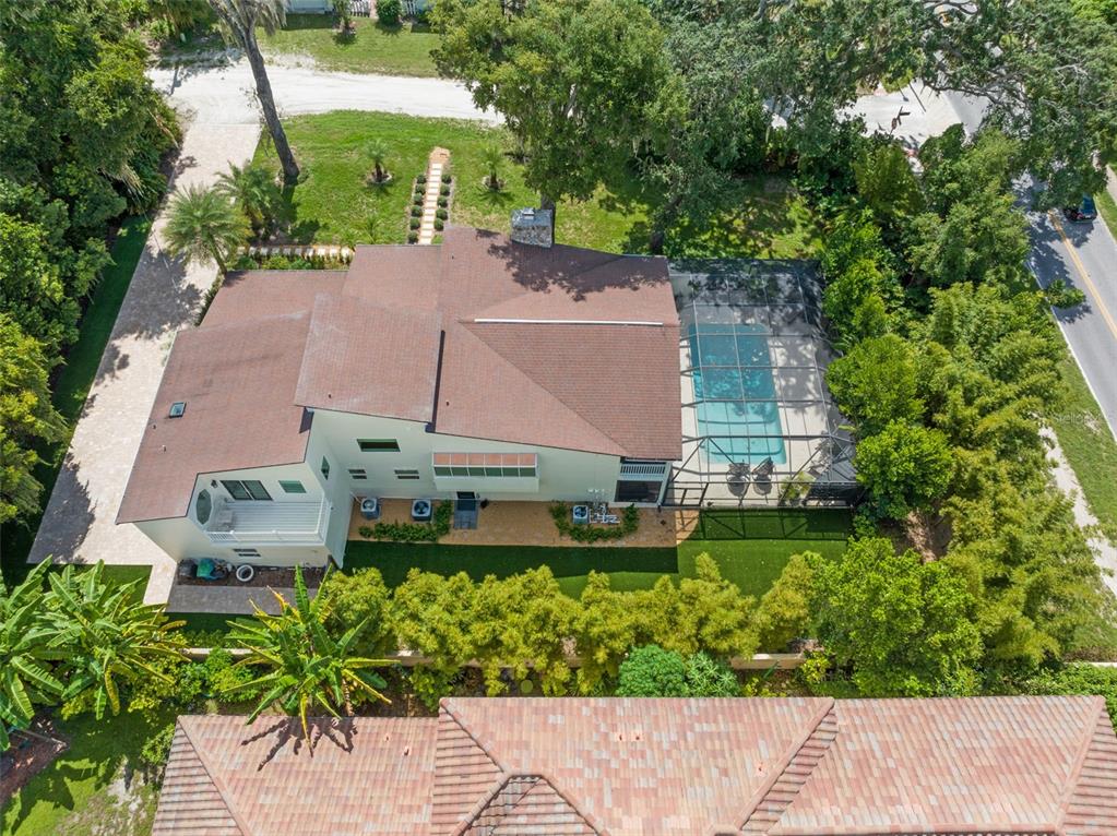 101 Lee Street Windermere, FL 34786 - Photo 4 of 63 an aerial view of a house with a garden and lake view