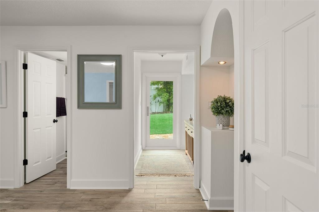 101 Lee Street Windermere, FL 34786 - Photo 45 of 63 a view of a hallway with wooden floor and a living room