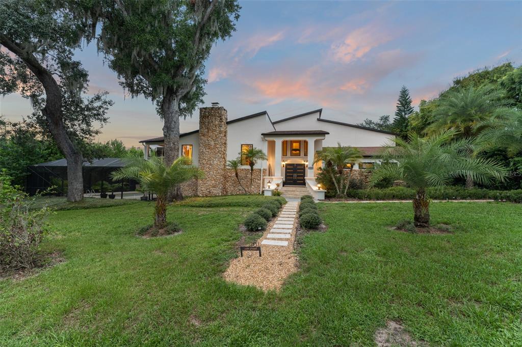 101 Lee Street Windermere, FL 34786 - Photo 57 of 63 a front view of a house with a garden and plants